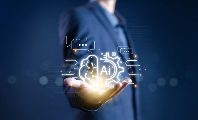 Businessperson hält KI-Symbol mit Chat- und Zahnradsymbolen, steht für digitale Innovation und IT-Lösungen der ISO-Gruppe.